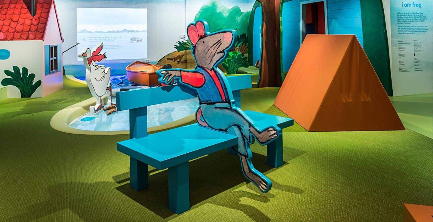 Mouse from the story of Frog on a bench in the Children's Book Museum