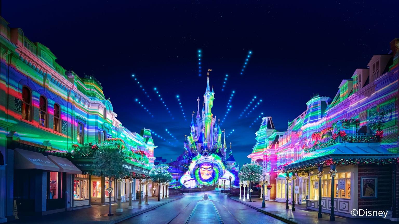 Main Street in Disneyland with colorful light show and the castle at the end of the street