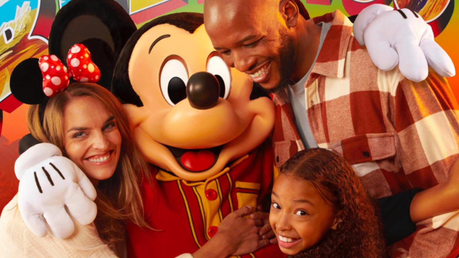 Family posing with Mickey Mouse during a Disney character meet at Disney Hotel Santa Fe.