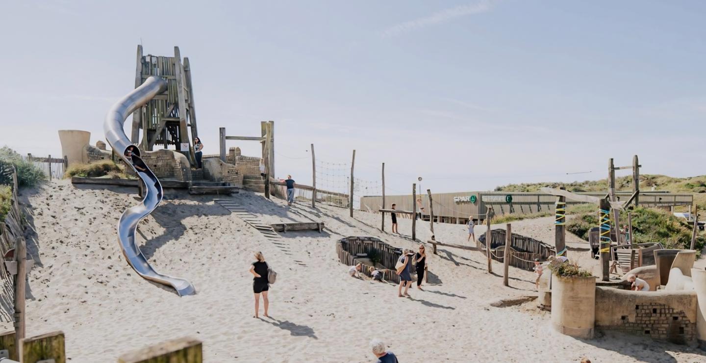 Outdoor playground with a large slide tower at Restaurant Gestrand