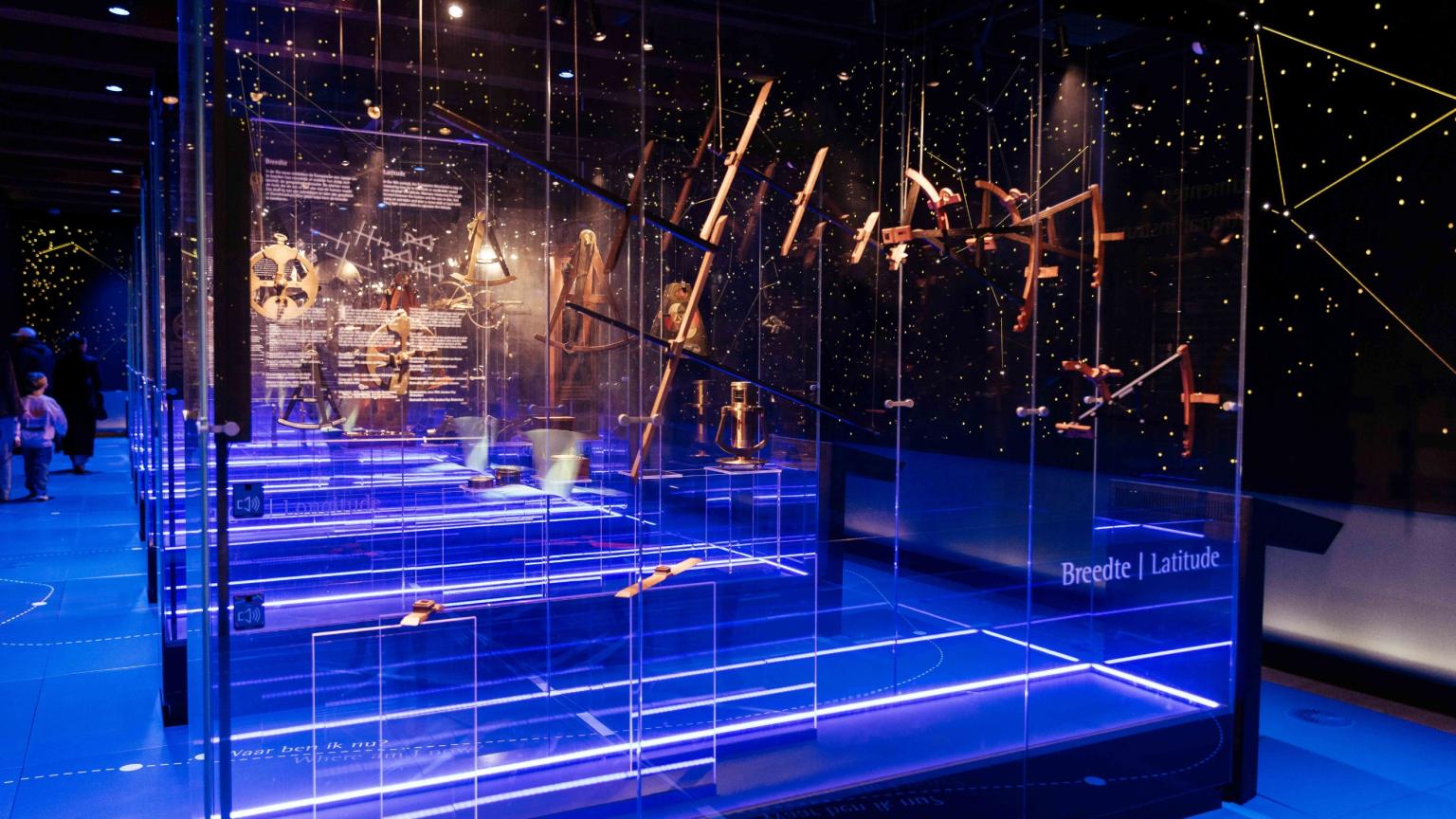 Historische navigatie-instrumenten in een donkere museumzaal, verlicht als een sterrenhemel in Het Scheepvaartmuseum.