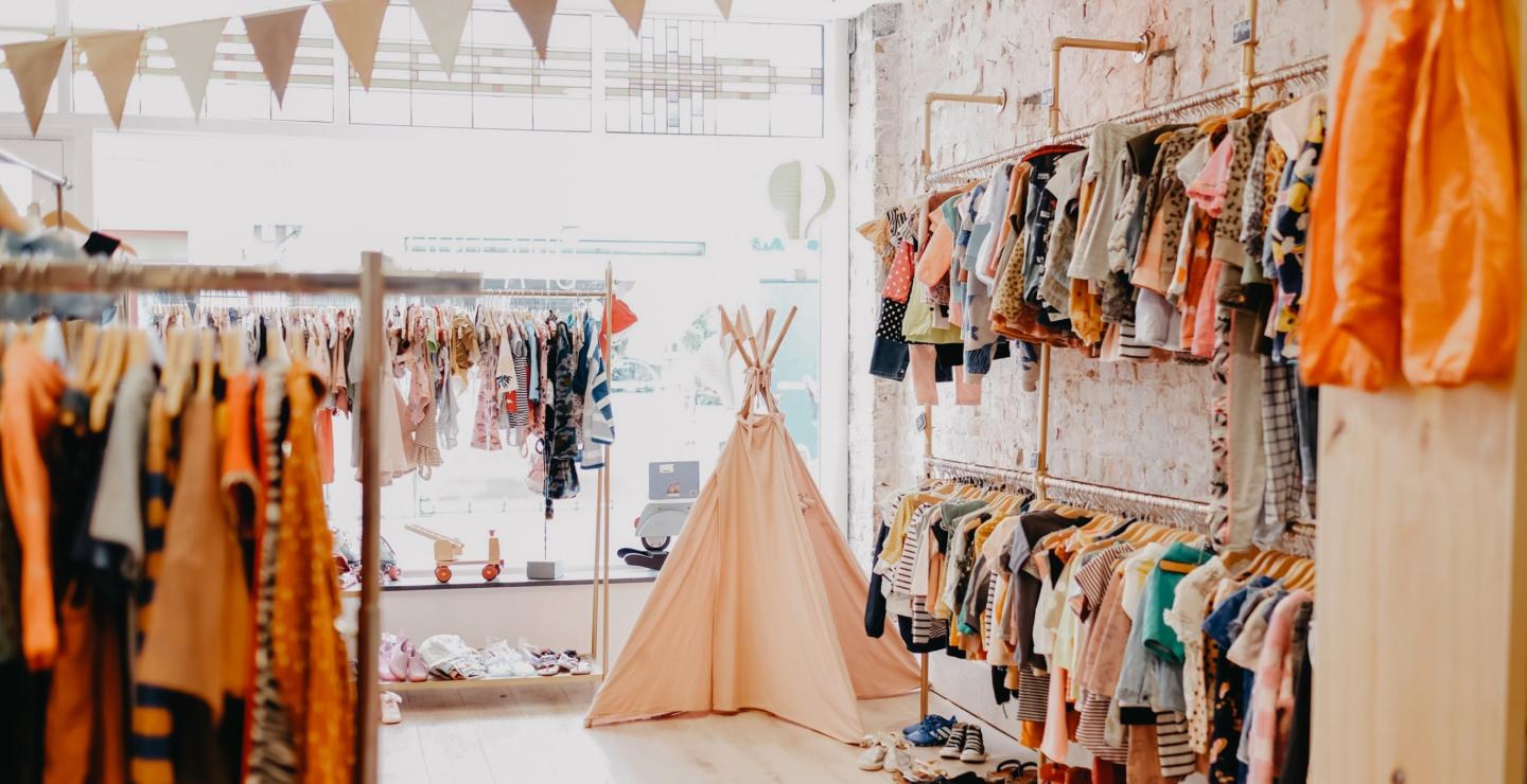Interior of the vintage children's clothing store Opa Drop, featuring various clothing items