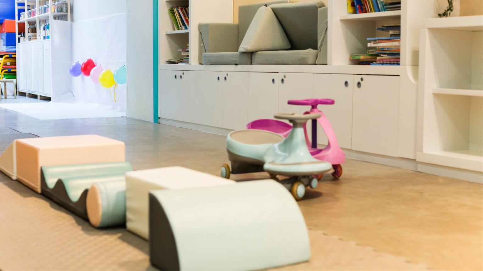 Play area at WOW Family Center with soft climbing blocks, ride-on toys and a child-friendly creative setup.